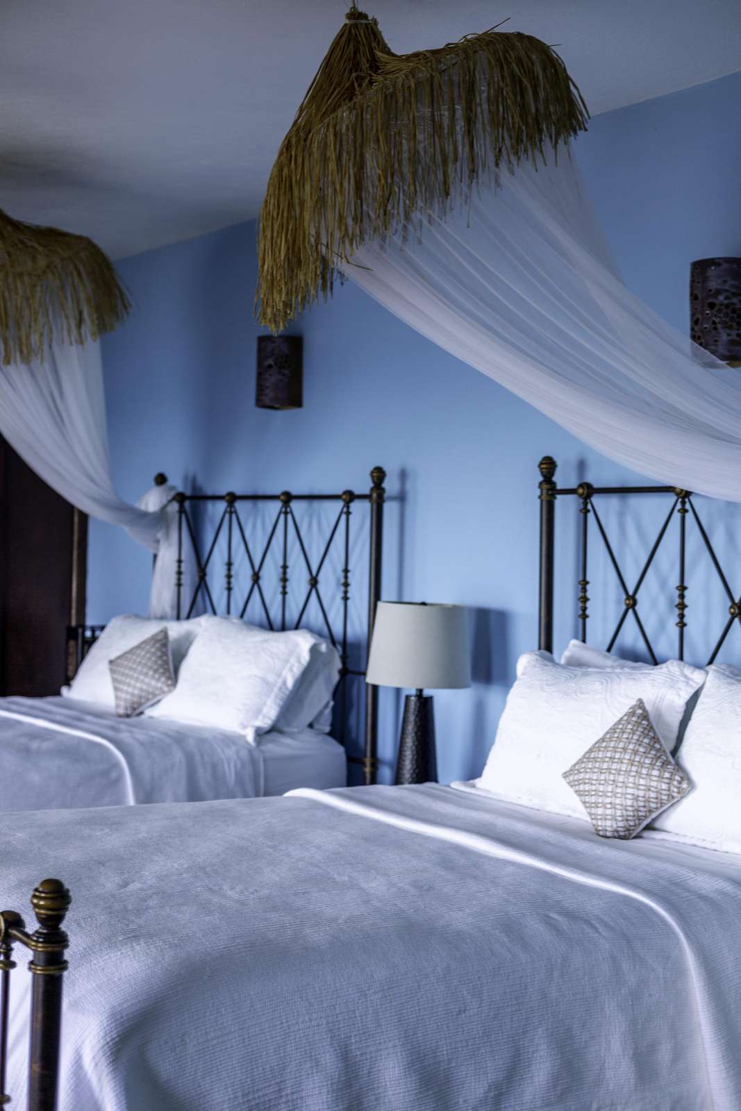 Cozy twin bedroom with charming canopy and soft lighting