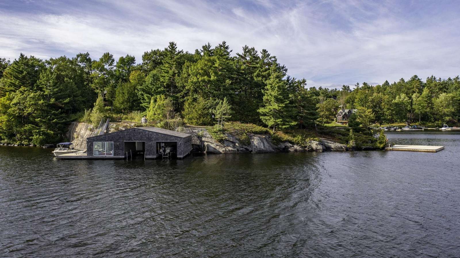 Waterfront boathouse with private dock and rocky shoreline