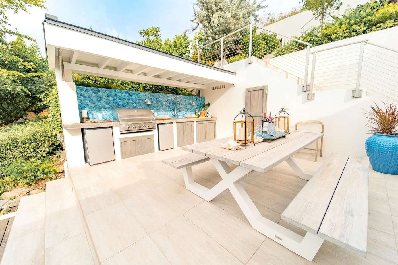 Sunlit outdoor kitchen, BBQ and dining area for memorable meals