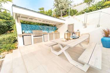 Sunlit outdoor kitchen, BBQ and dining area for memorable meals