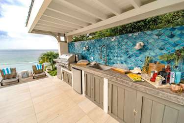 Oceanview outdoor kitchen and pool deck above Long Bay beach