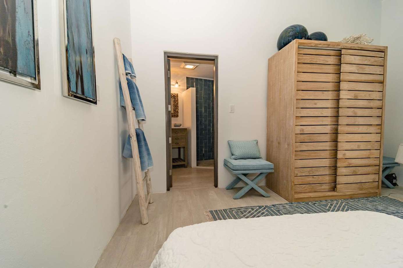 Beautiful coastal living style furniture and soft furnishings and an ensuite bathroom with shower in Bedroom 3