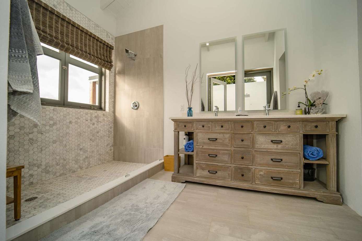 Primary Suite: Luxurious bathroom with indoor and private outdoor shower