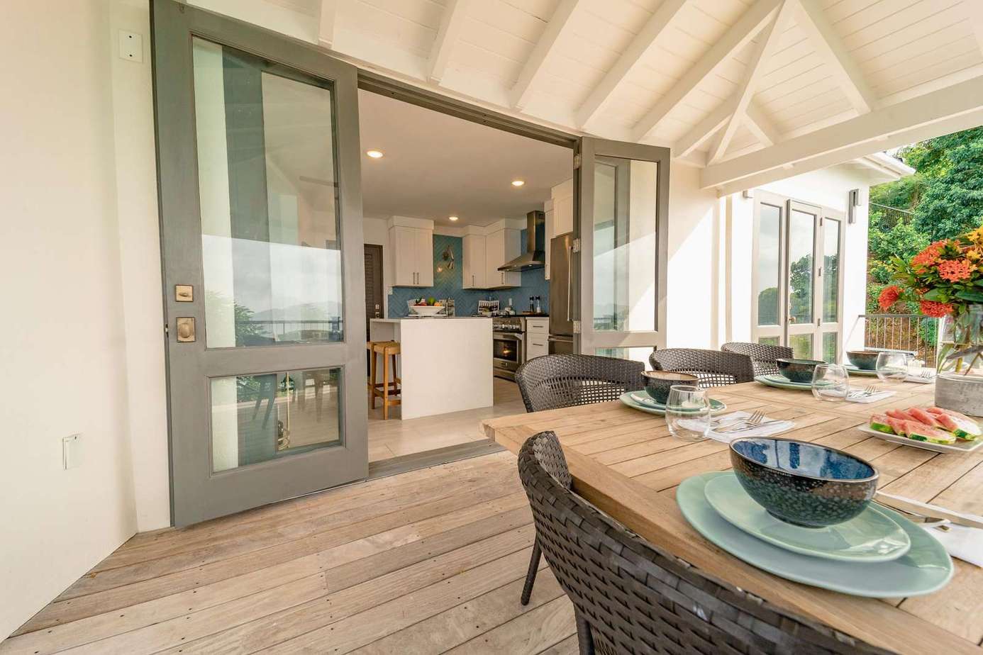 the covered dining porch adjacent to the kitchen is perfect for any meal of the day, and the view only adds to the fun
