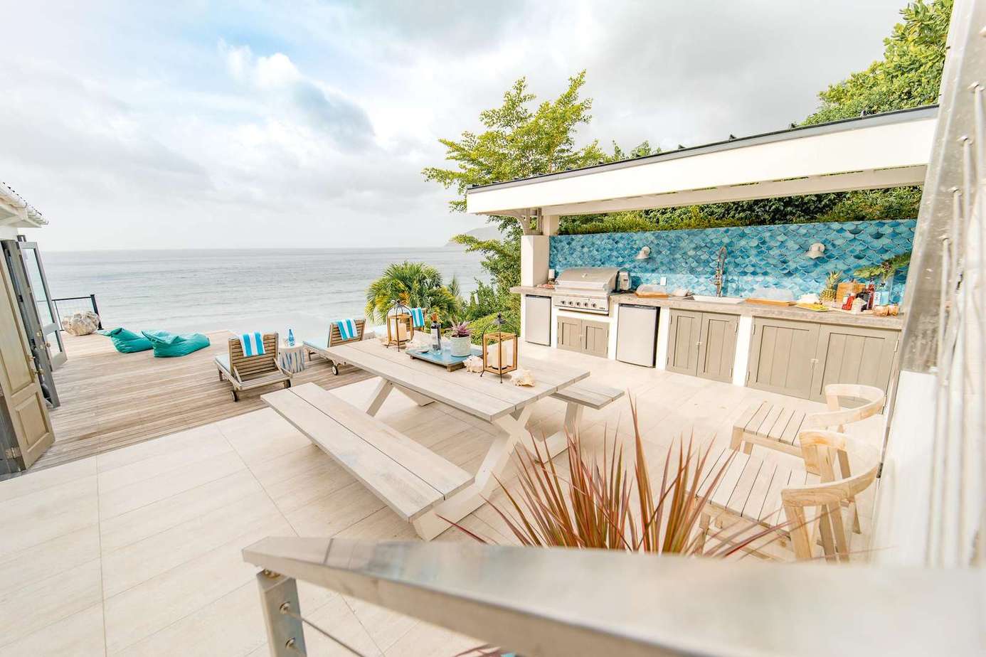 Relaxed seating for everyone on the tiled BBQ deck leading down to the wooden pool deck. A 5th bathroom with shower is conveniently located off the deck.