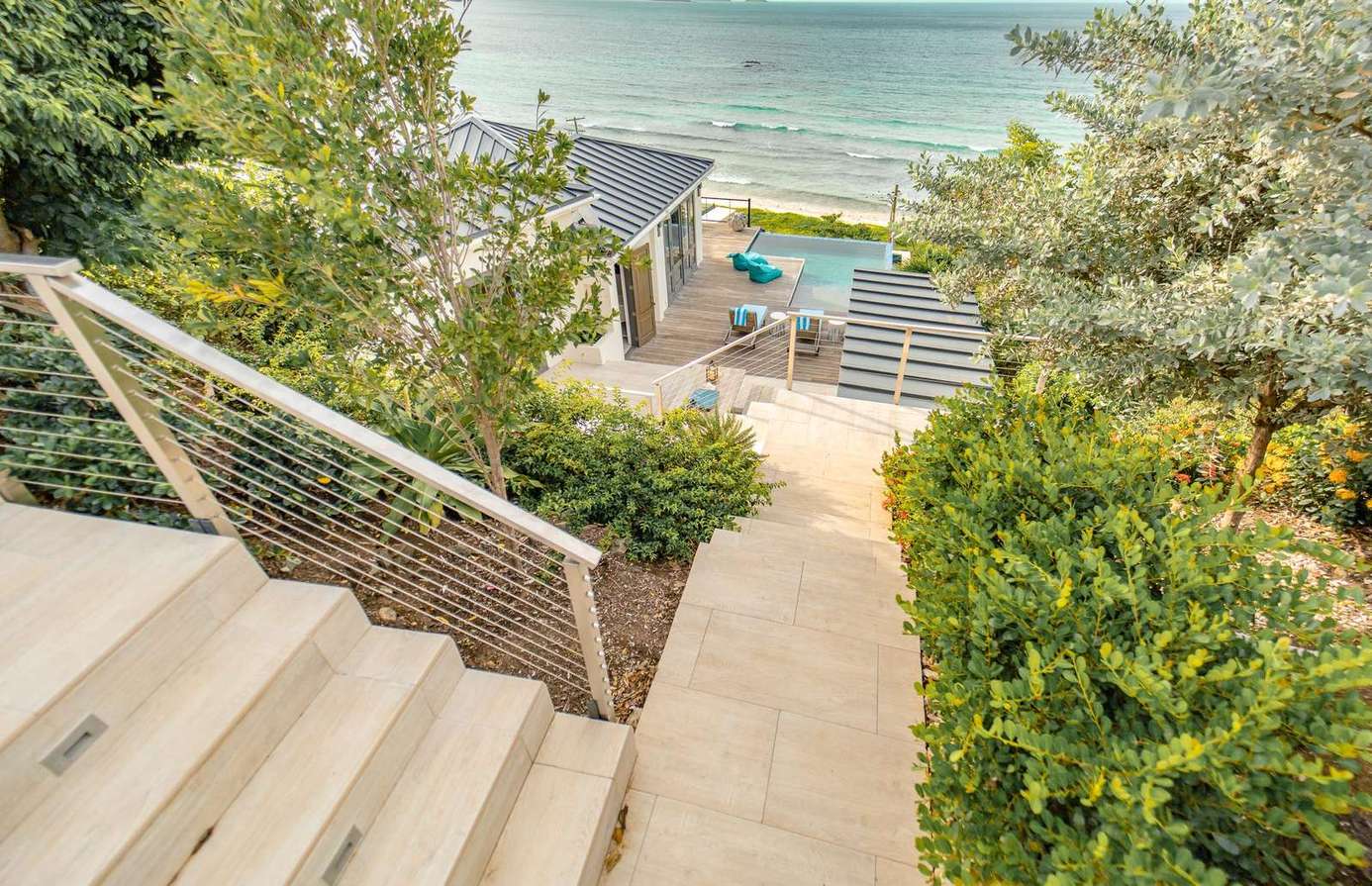 A few stairs lead up from the pool and BBQ deck to the tranquility and privacy of the Primary Suite