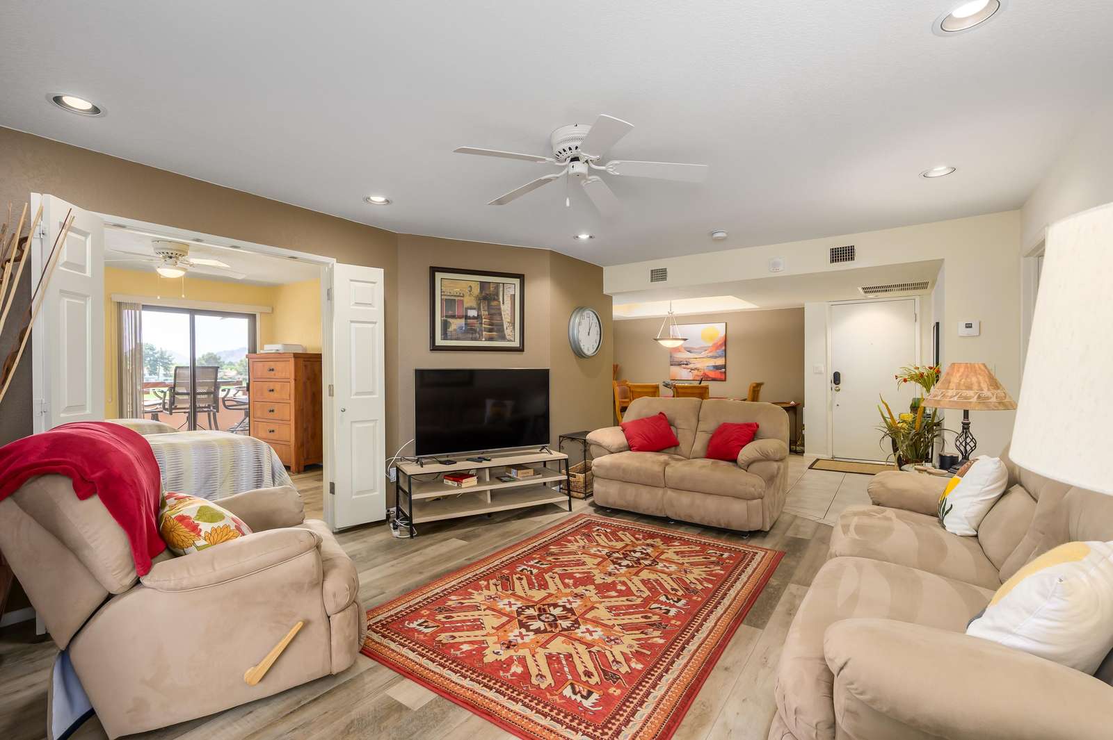 Spacious living room with cozy seating and vibrant accents - property