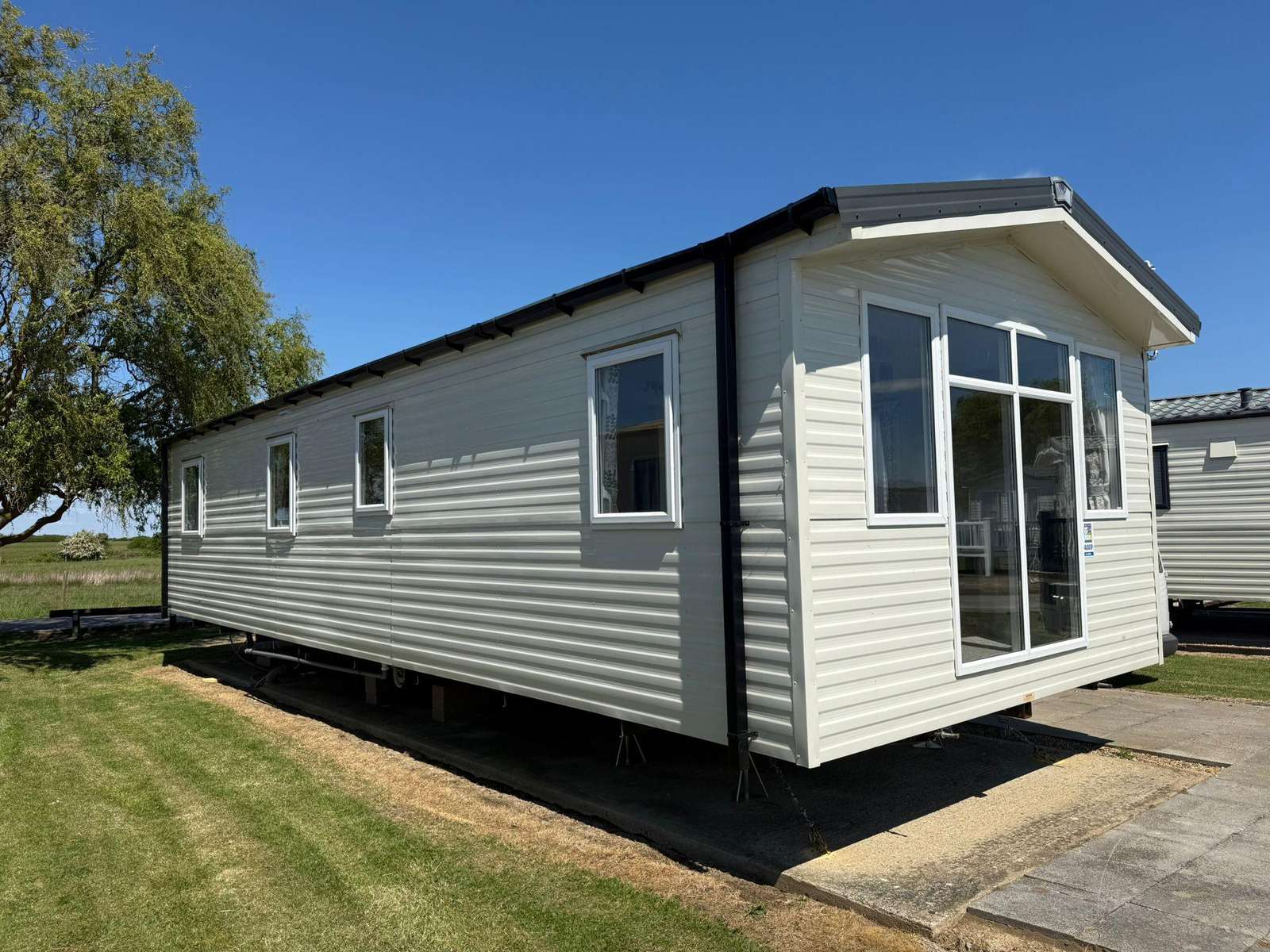 Modern holiday caravan exterior at Steeple Bay Holiday Park for a family holiday UK. - property
