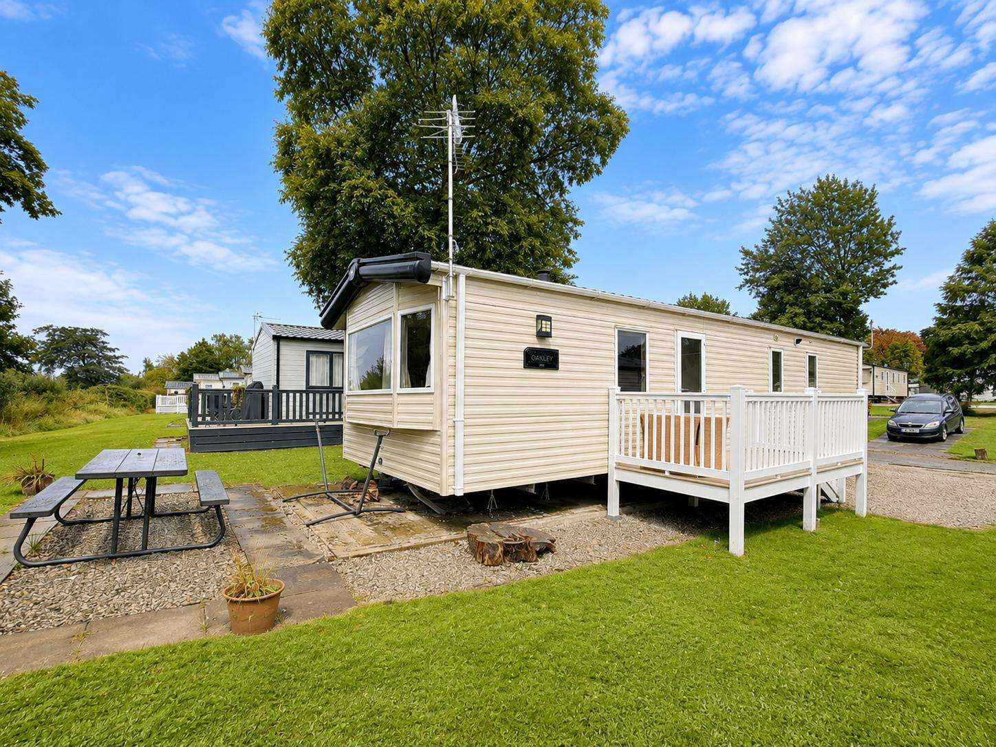Tucked away on a quiet, scenic plot at Bowland Fell Holiday Park in Yorkshire, this charming cream caravan offers the perfect escape. - property