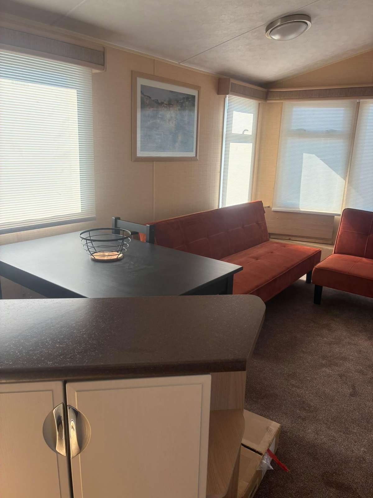 Open-plan caravan lounge and dining area - property