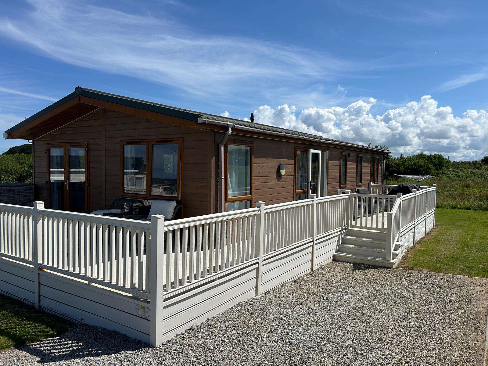 Modern 2-bedroom holiday lodge at Trevella Holiday Park near Newquay, Cornwall, sleeping up to 4 guests with a large private wraparound decking area. - property