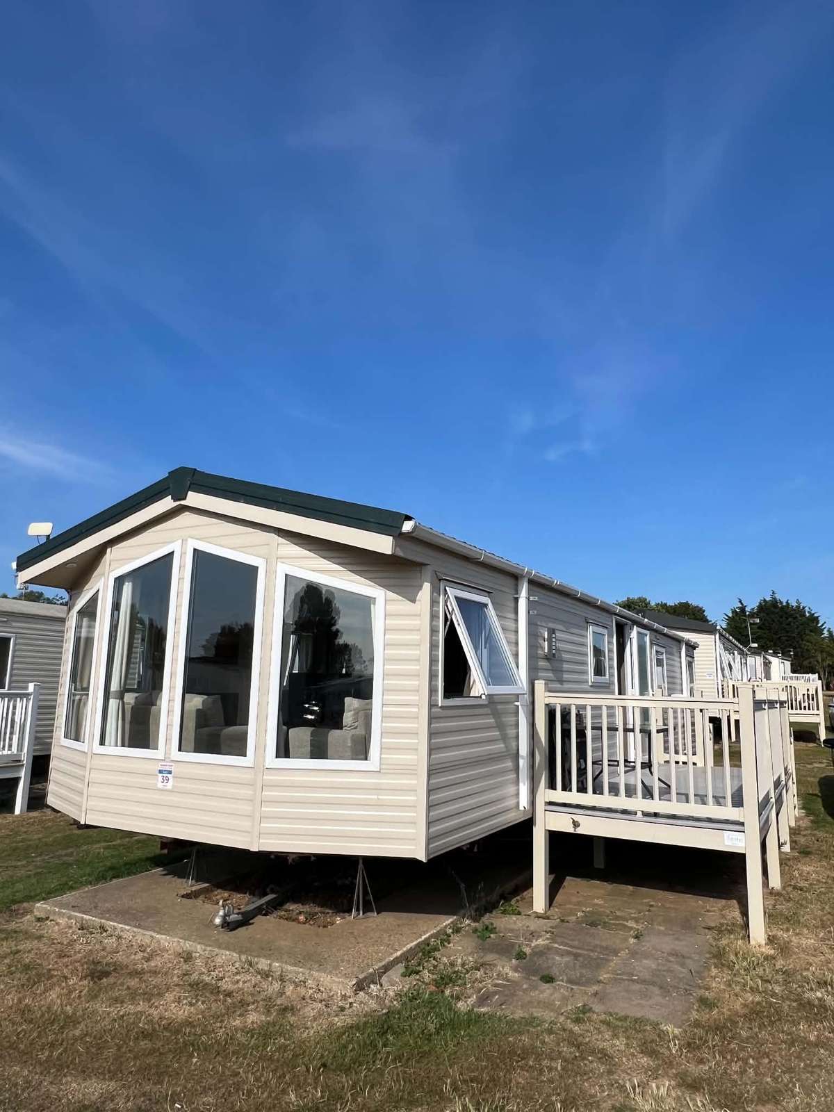 Elevate your next seaside escape with this stunning caravan with decking, offering the perfect outdoor sanctuary for you to relax while the sun sets. - property