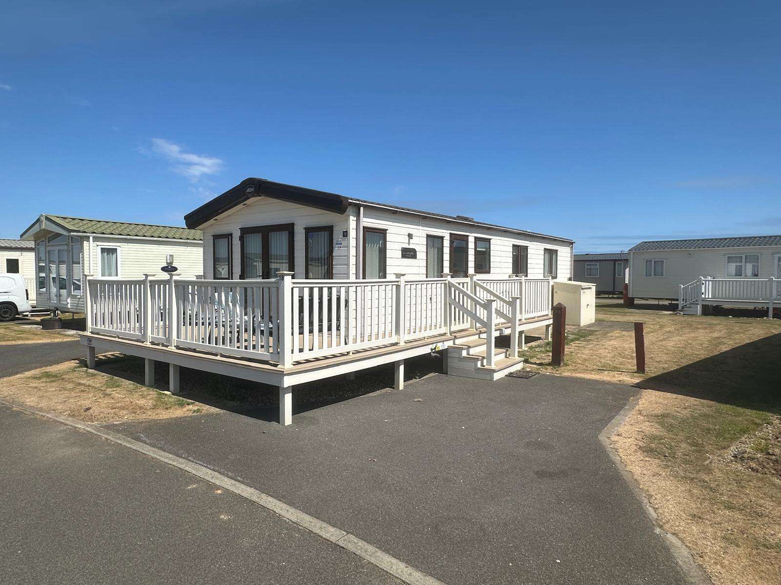 Exterior of the 2 bedroom caravan with spacious decking at Barmston Beach Holiday Park. - property