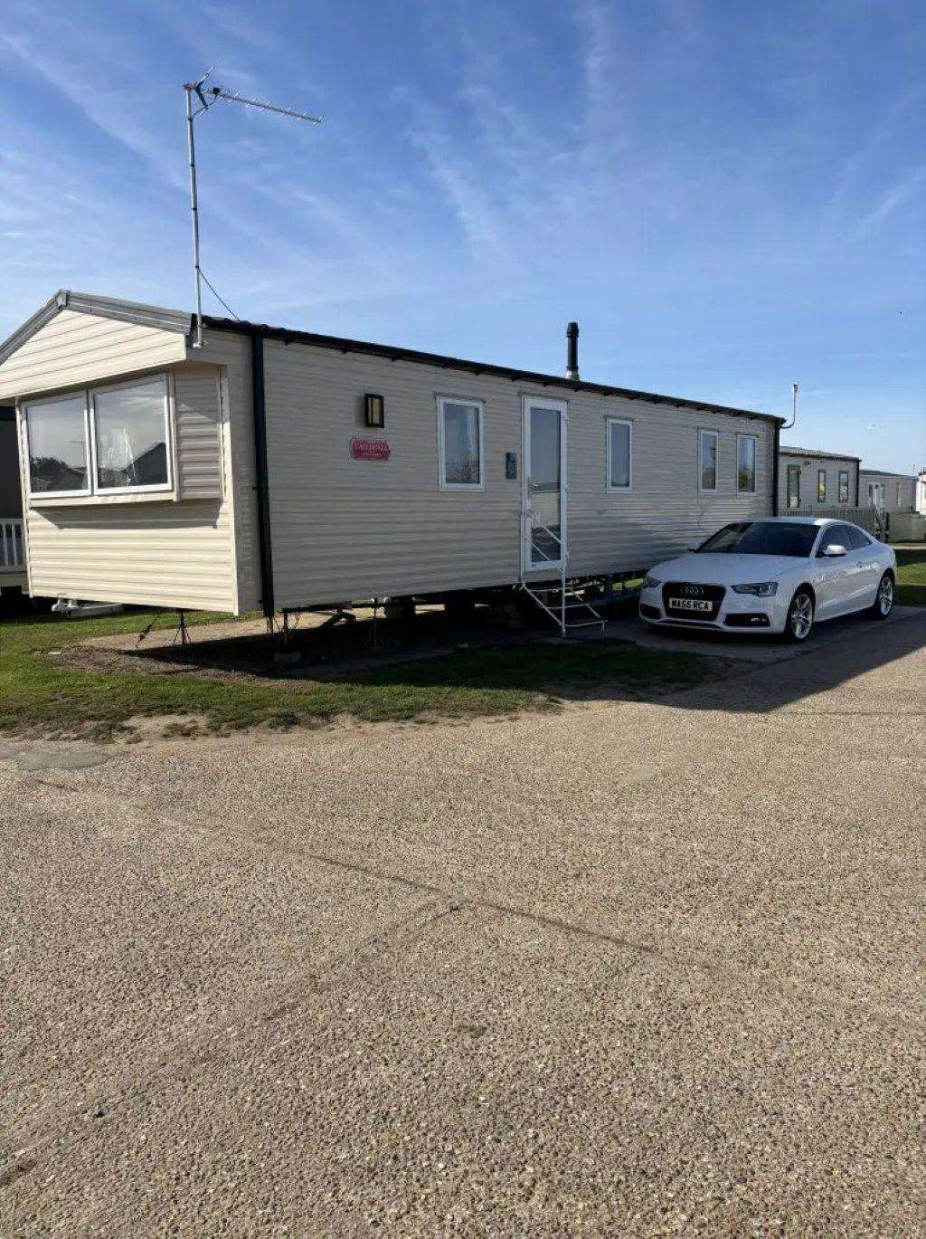 Number 107 caravan exterior with parking at Broadland Sands Holiday Park - property
