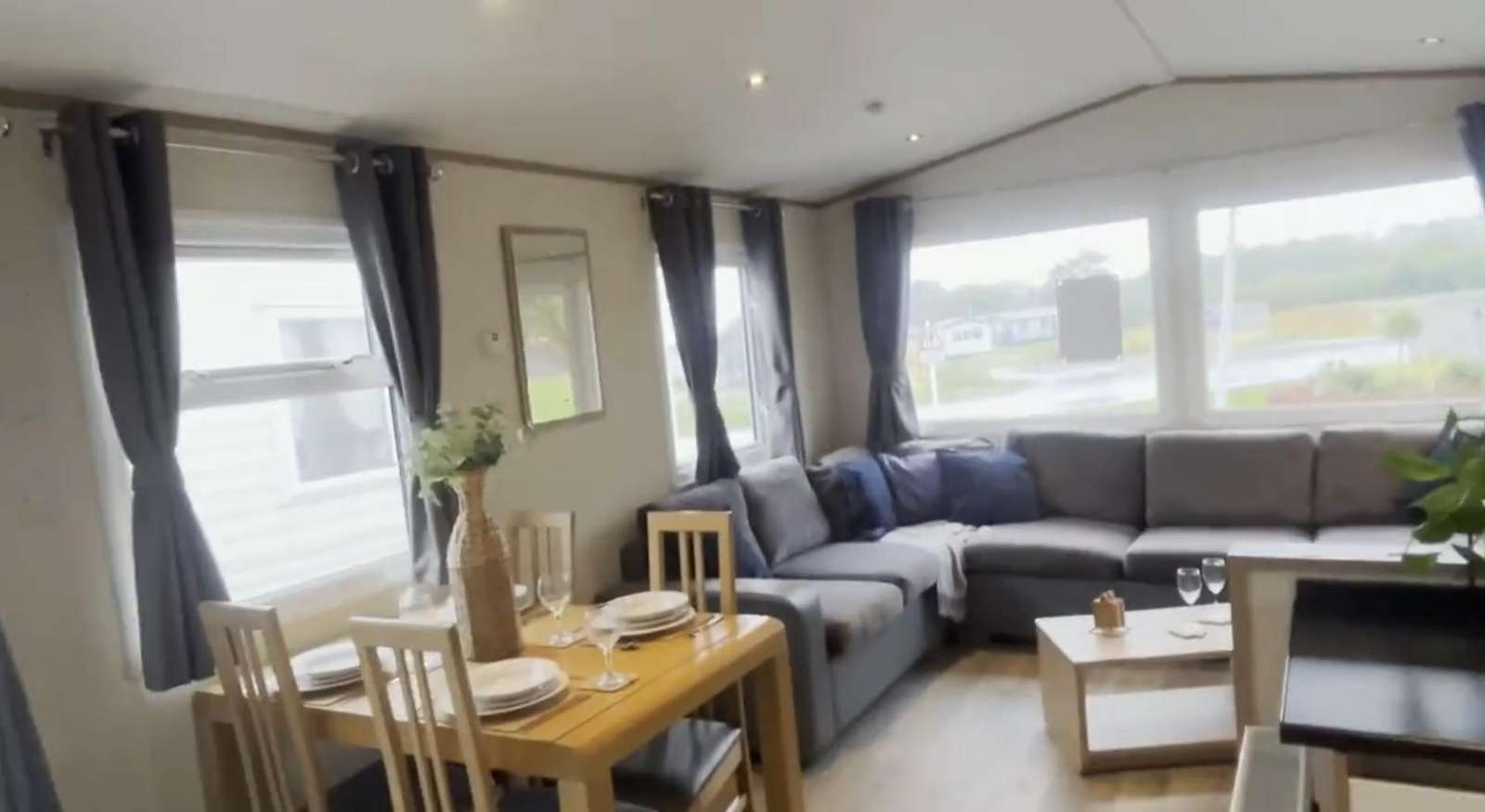 Dining and lounge area inside caravan 258 at Broadland Sands - property