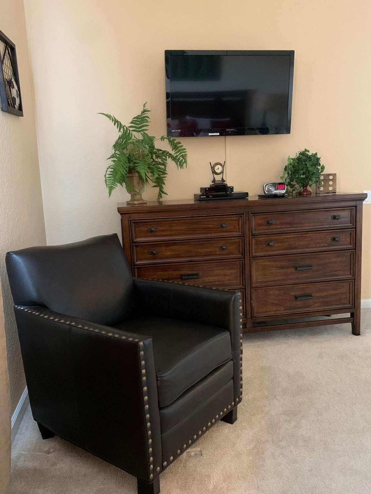 Sitting area in master bedroom, flat screen TV and DVD player