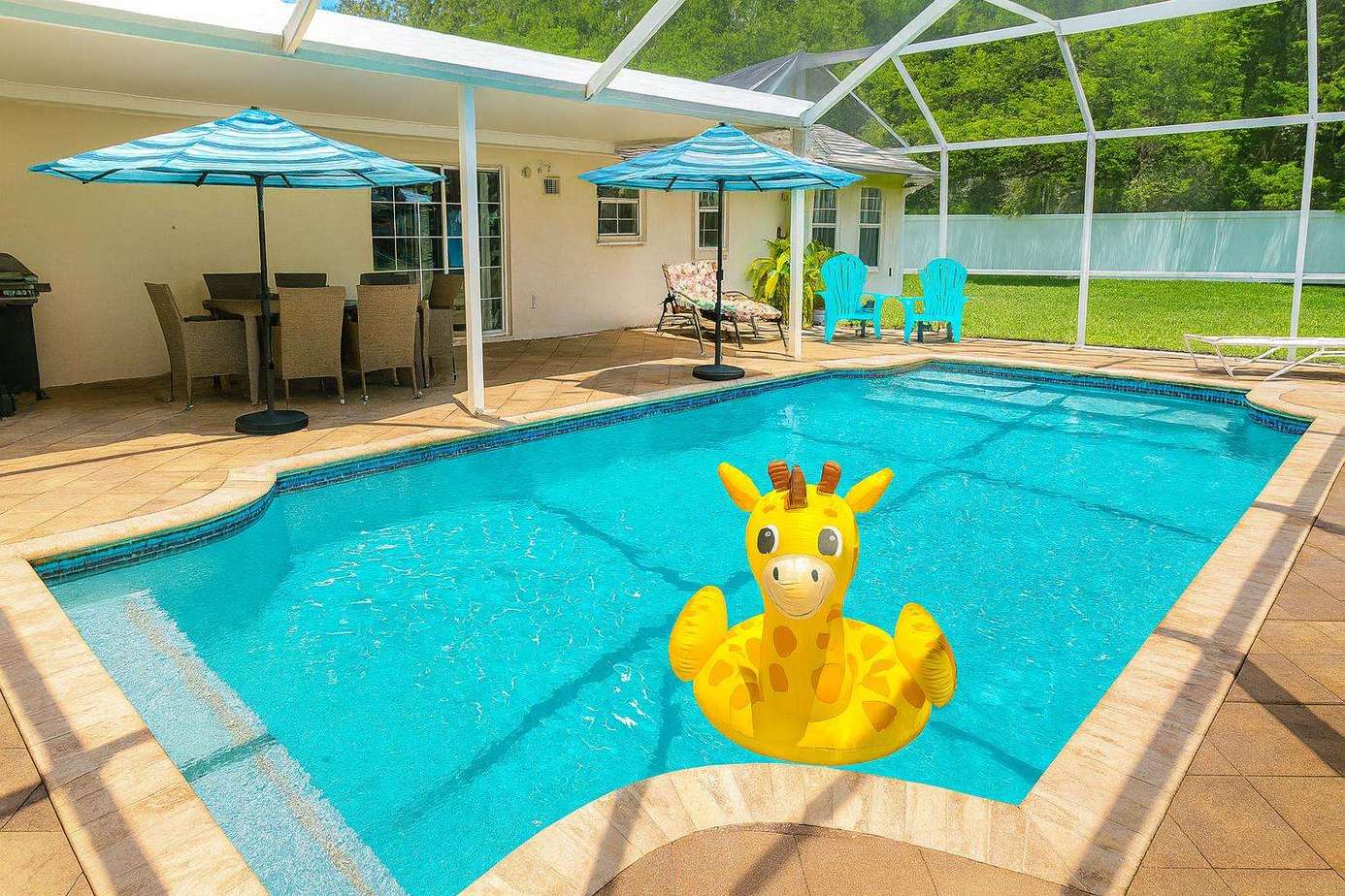 Sunlit poolside retreat with shaded lounge and dining area - property