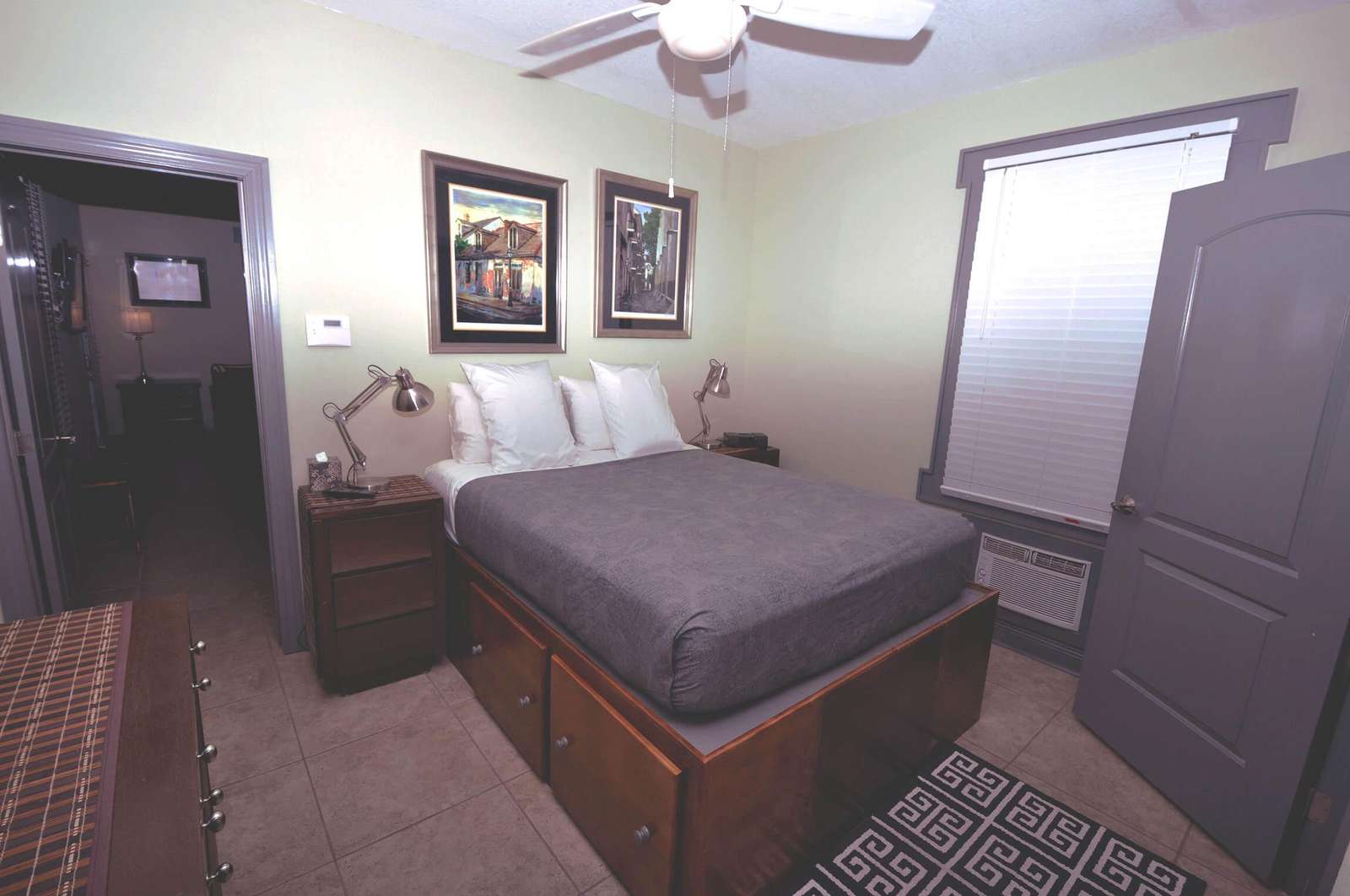 Queen bed with storage drawers custom built into bedframe.