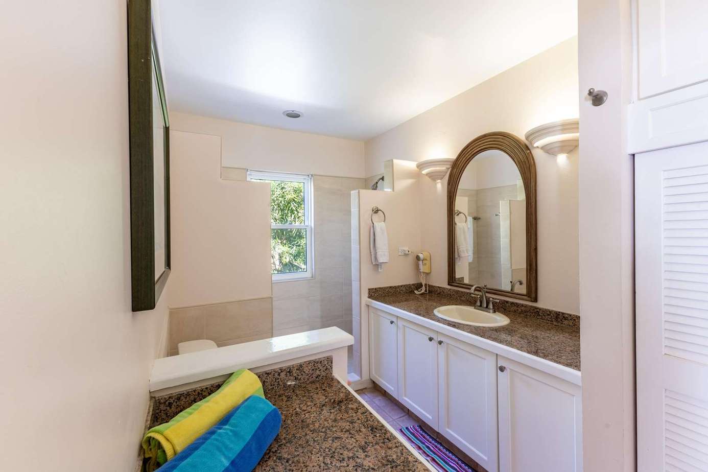 Bright, airy bathroom with dual sinks and garden view window