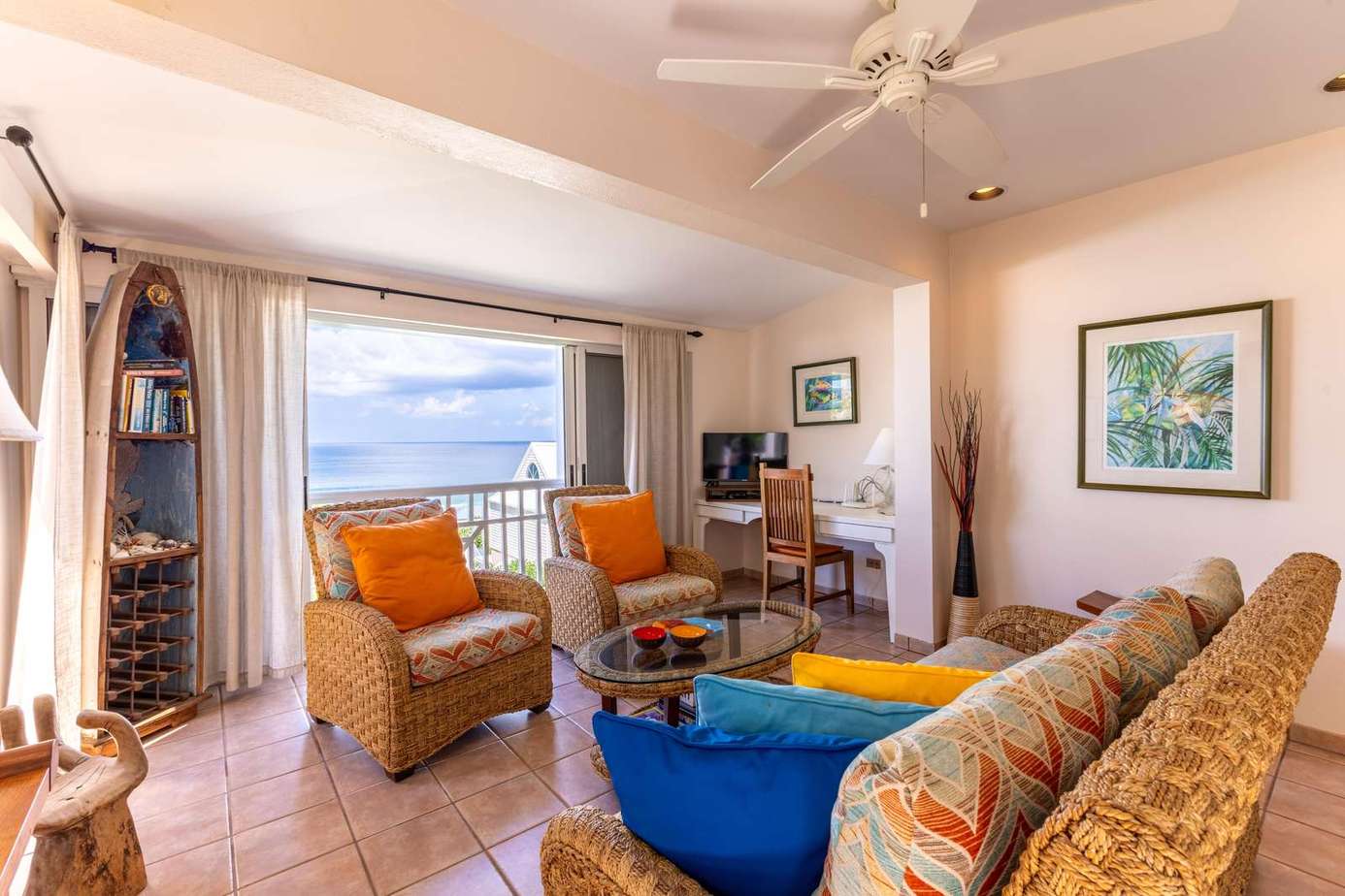 Sunlit living room with ocean views and cozy seating