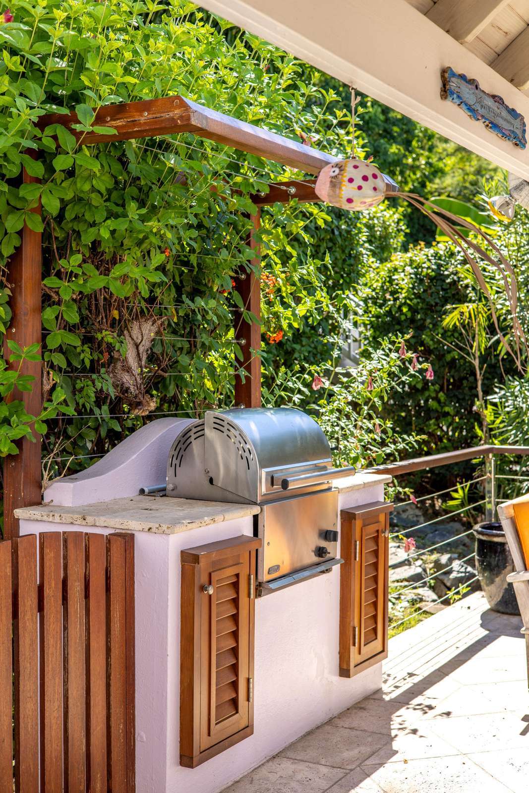 Outdoor kitchen with lush vertical garden and natural light