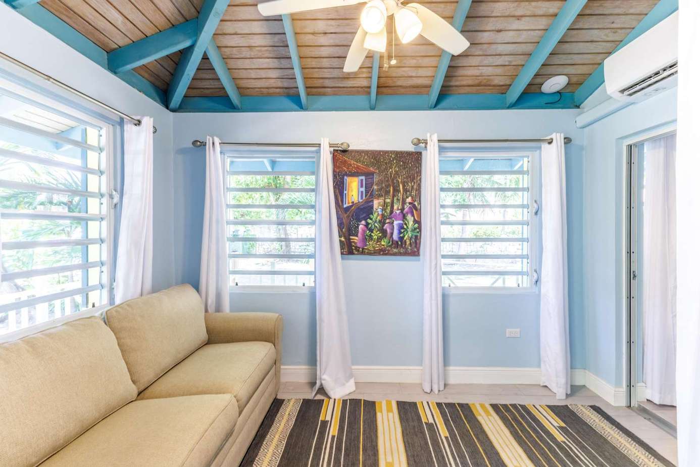 Bright and airy sunroom with cozy seating and vibrant accents
