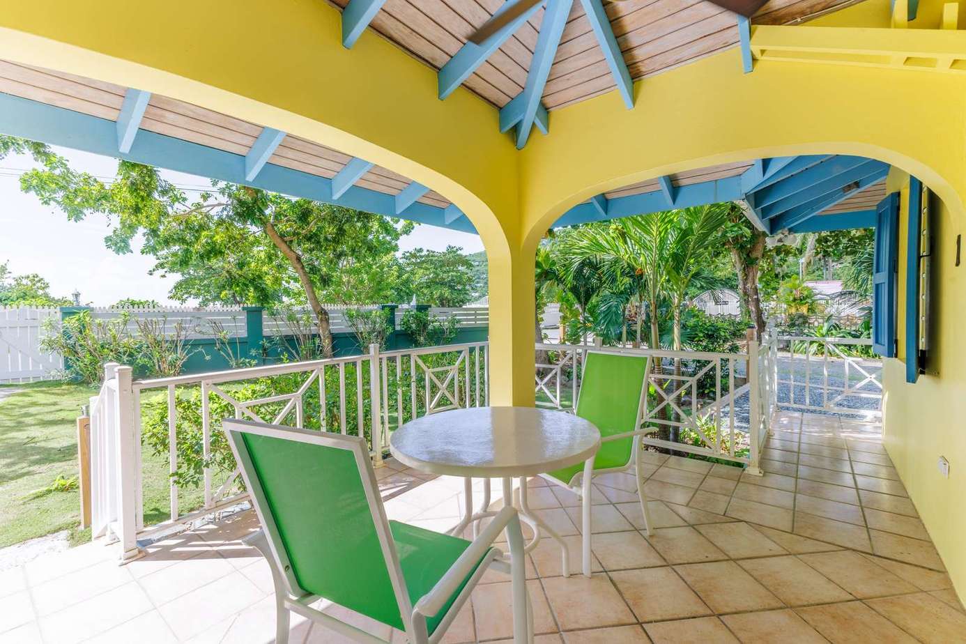 Sunny covered patio with vibrant colors and garden views
