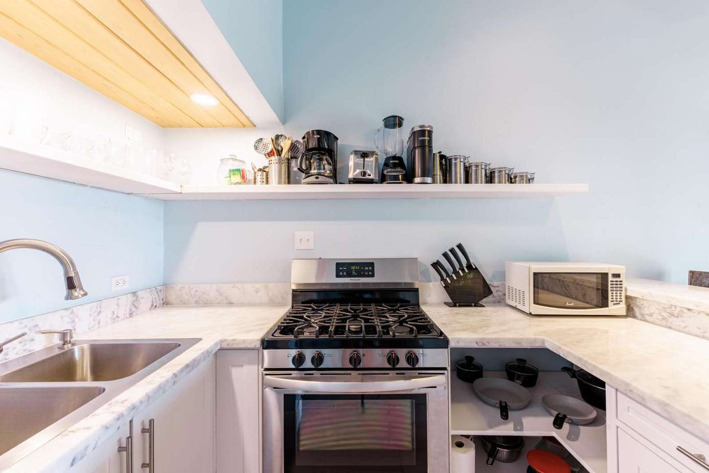 Bright, modern kitchen with sleek appliances and open shelving