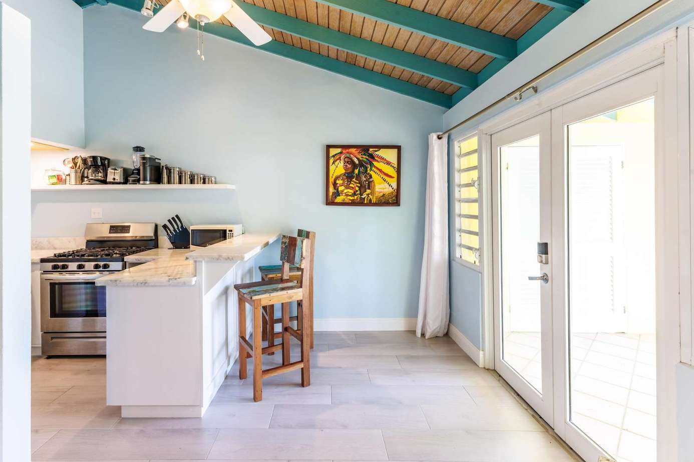 Bright kitchen with vaulted ceilings and sunny patio access