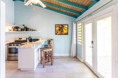 Bright kitchen with vaulted ceilings and sunny patio access