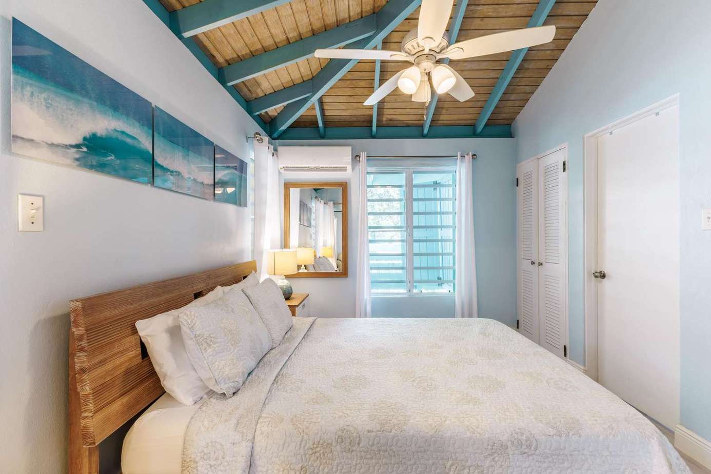 Cozy bedroom retreat with vaulted ceilings and ocean art