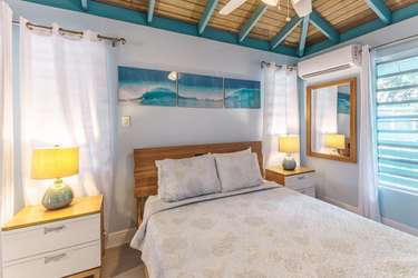 Cozy bedroom retreat with vaulted ceilings and natural light