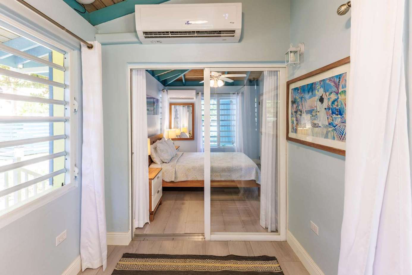 Bright, airy bedroom with private balcony access and ocean breeze