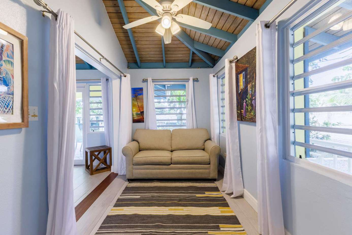 Cozy sunlit sitting area with vaulted ceiling and natural light