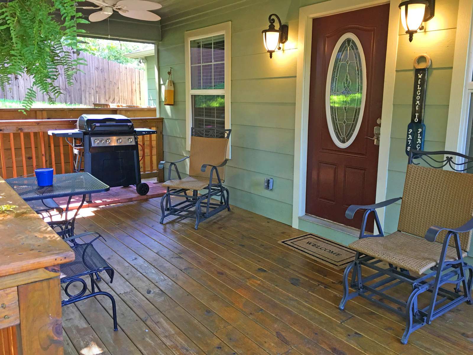 The front porch with gas grill, table, chairs and fans! The grill is attached to a large tank (no running out of gas)