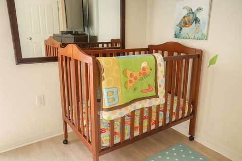 Cozy nursery corner with charming wooden crib and playful decor