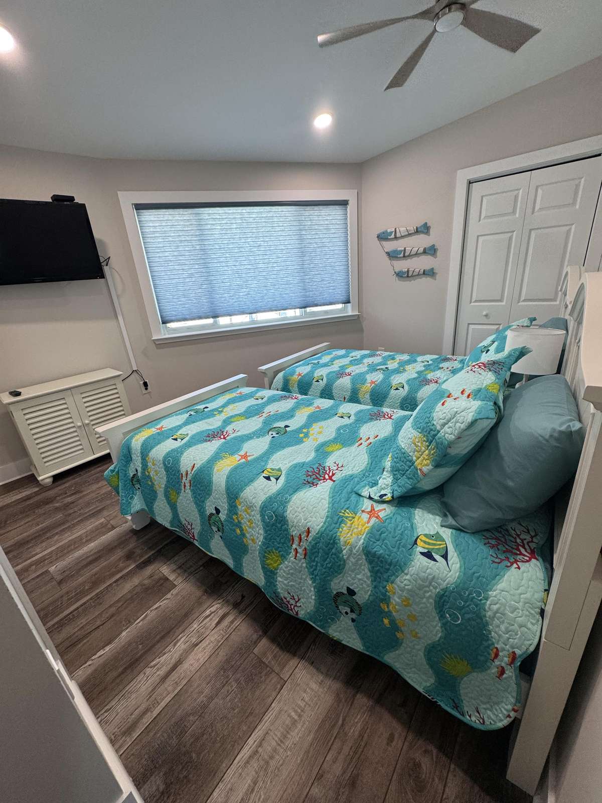 Twin bedroom with vibrant coastal-inspired decor