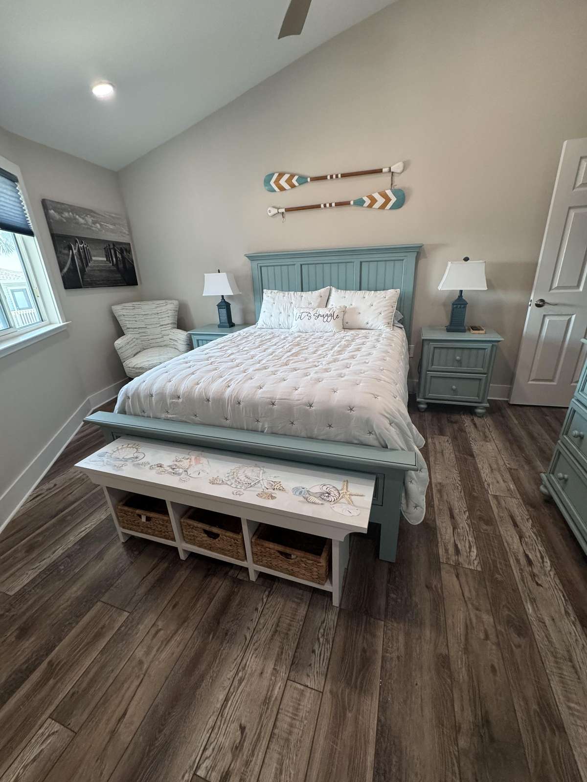 Cozy master bedroom with vaulted ceiling and natural light