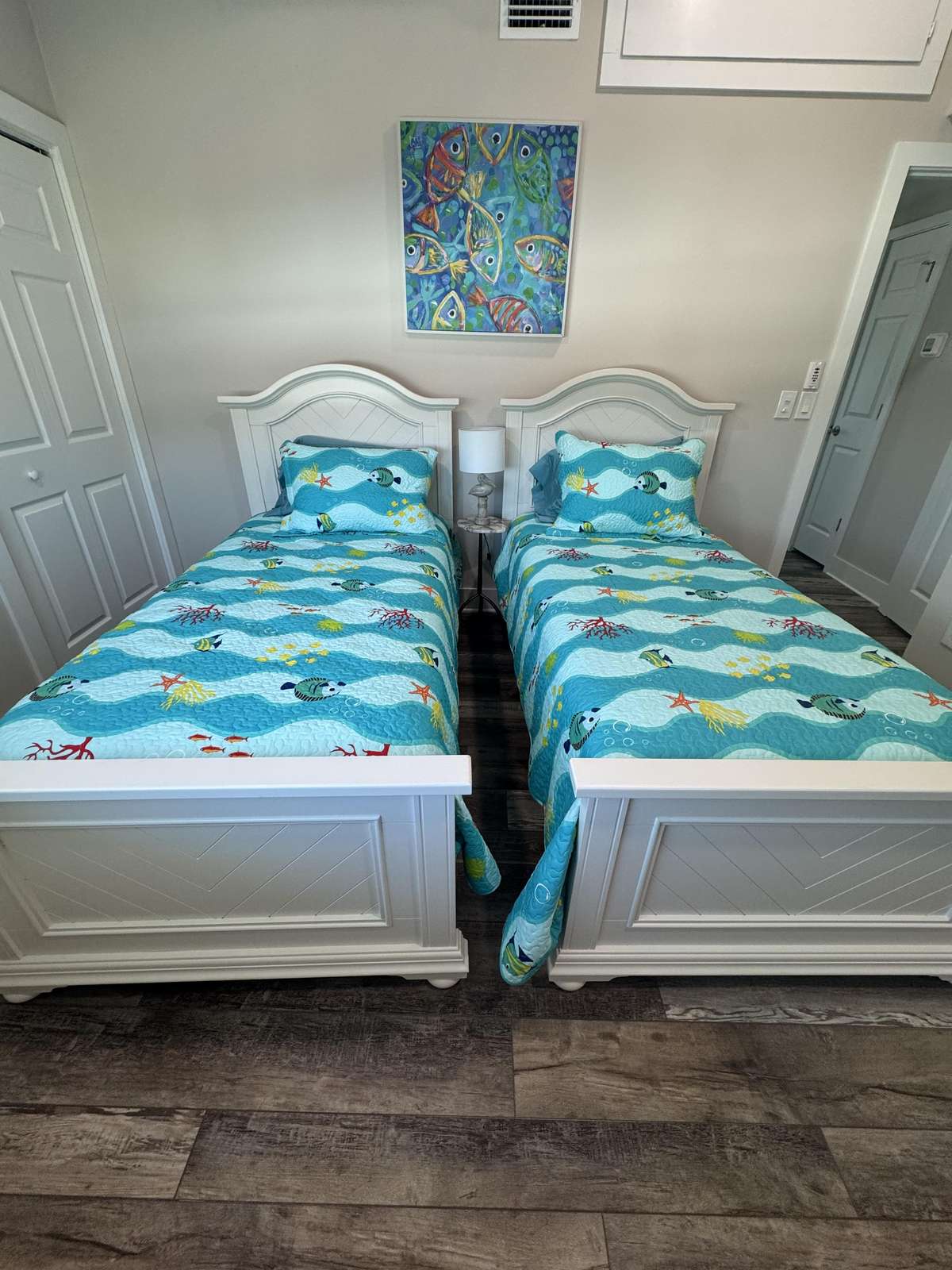 Twin bedroom with vibrant coastal-inspired decor
