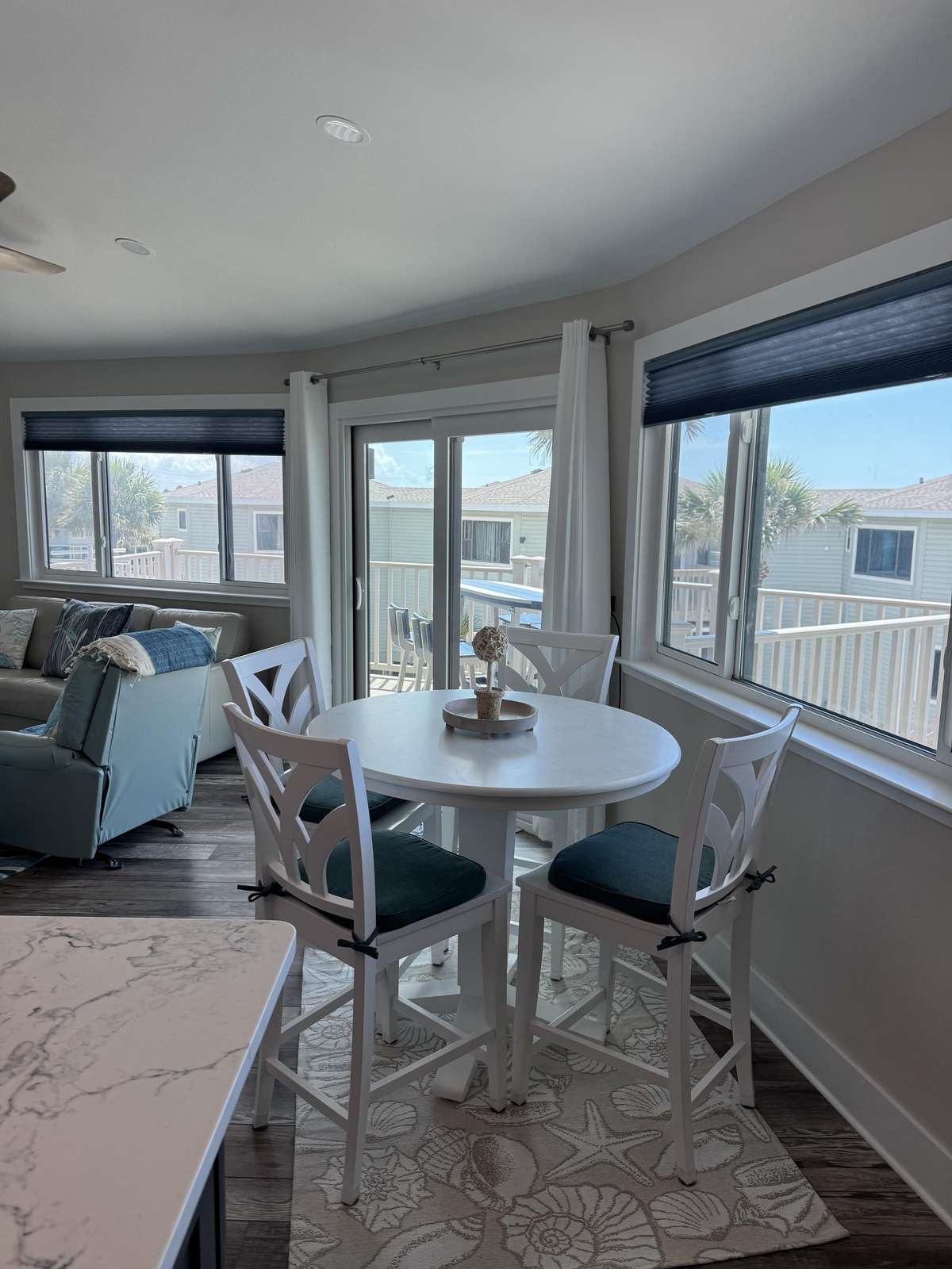 Sunlit dining nook with panoramic window views