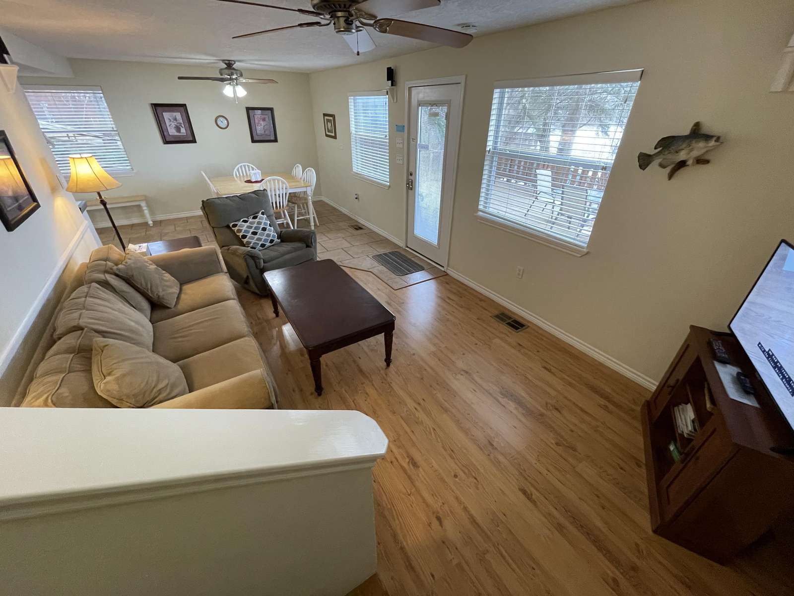 The living area looking into the dining with the kitchen around the corner! The windows overlook the deck and the lake.e.