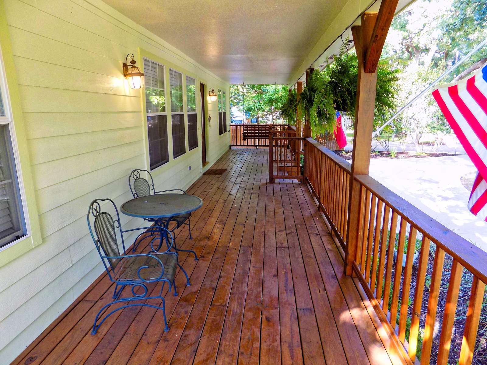 The front porch with table, chairs and a swing. The perfect spot for a book.