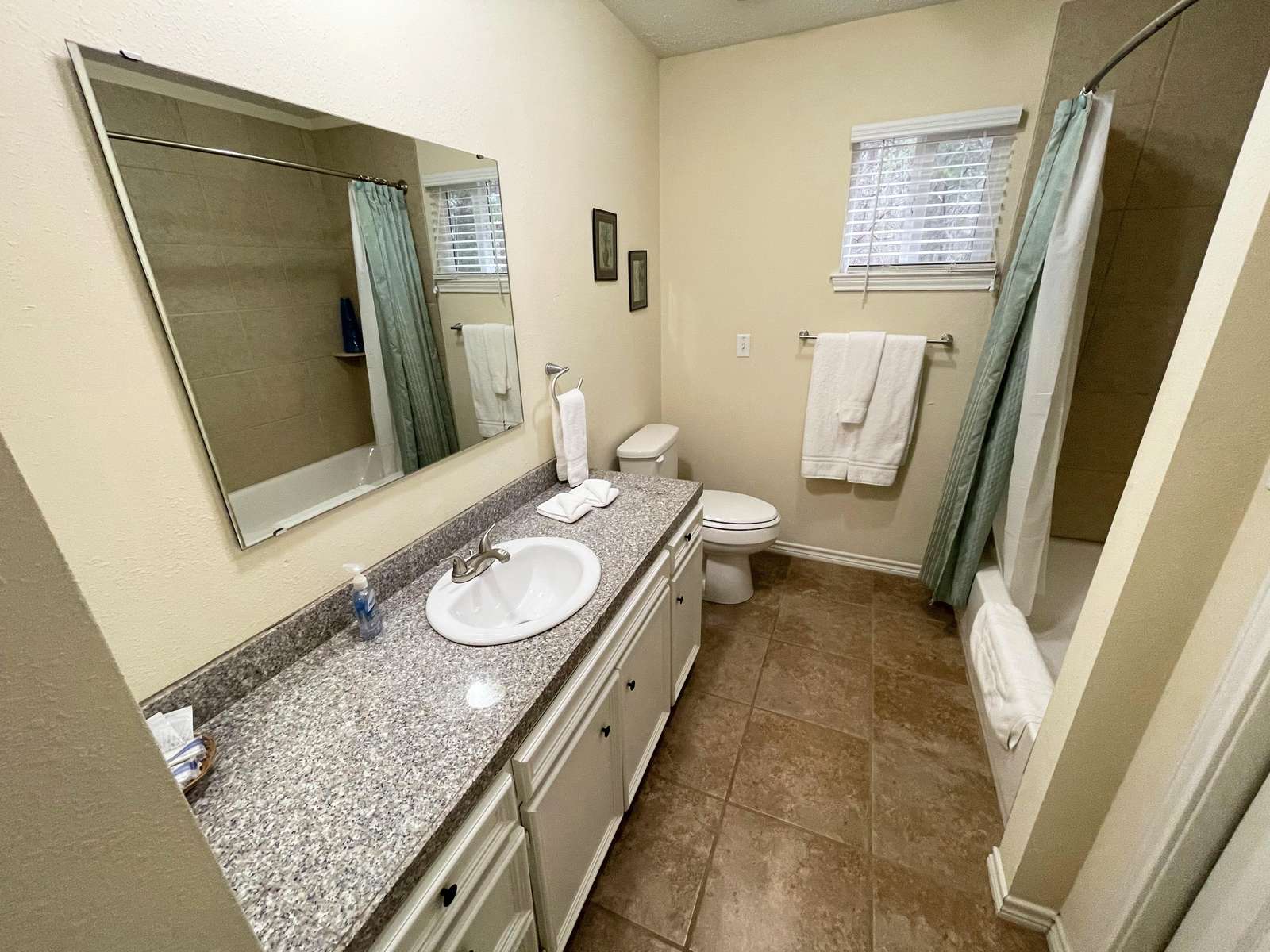 The Master Bathroom with tiled tub/shower unit.