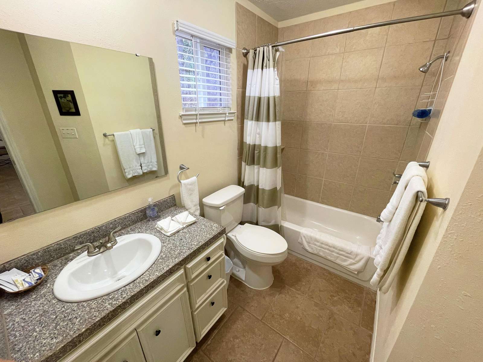 The hall Bathroom with tiled Tub/Shower.
