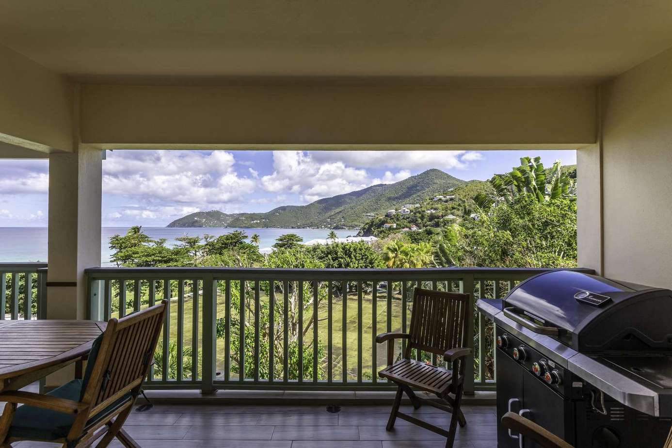 Spacious balcony with scenic mountain views and grill area