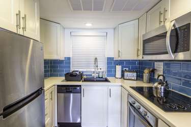 Bright kitchen with modern appliances and vibrant blue backsplash