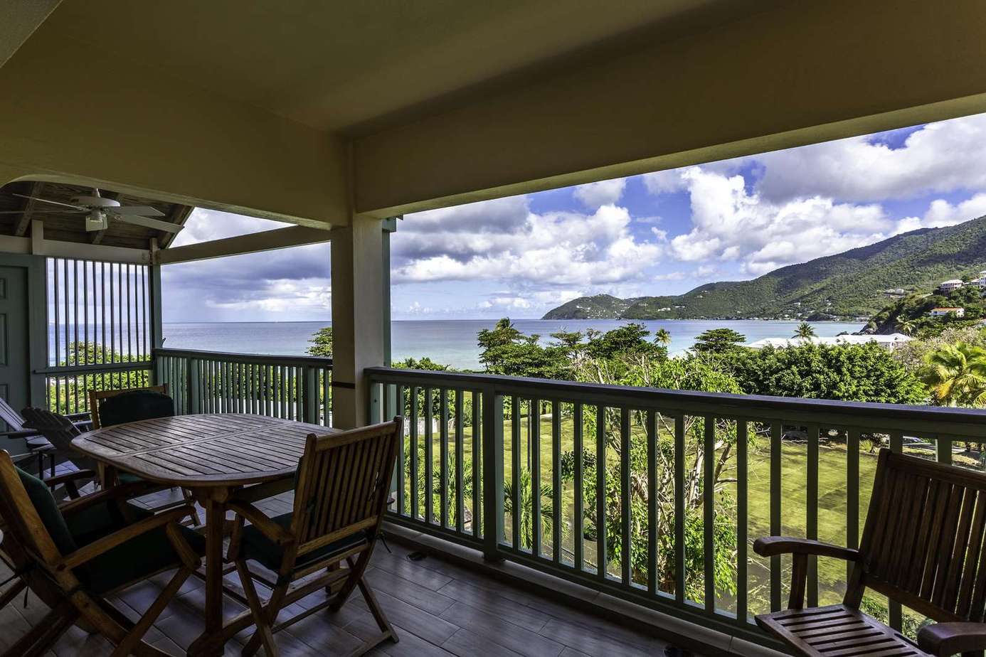 Spacious covered balcony with ocean and mountain views