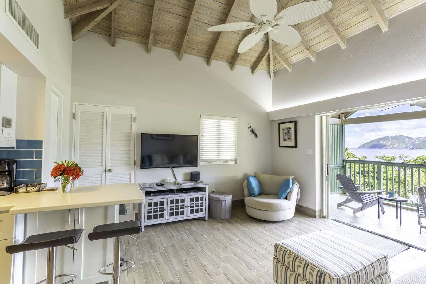 Bright open living room with vaulted ceilings and balcony views
