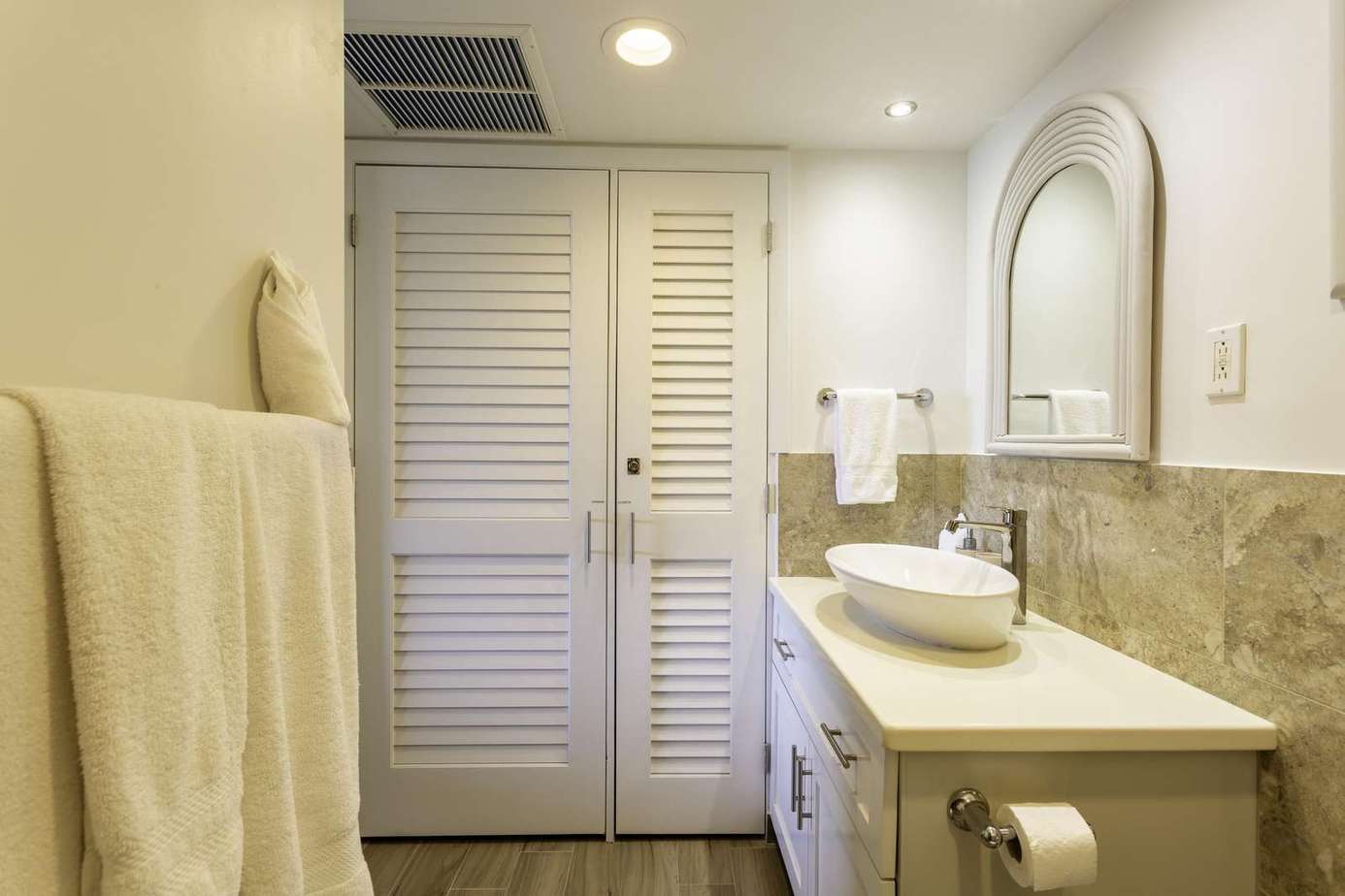 Bright, modern bathroom with elegant stone accents and ample storage
