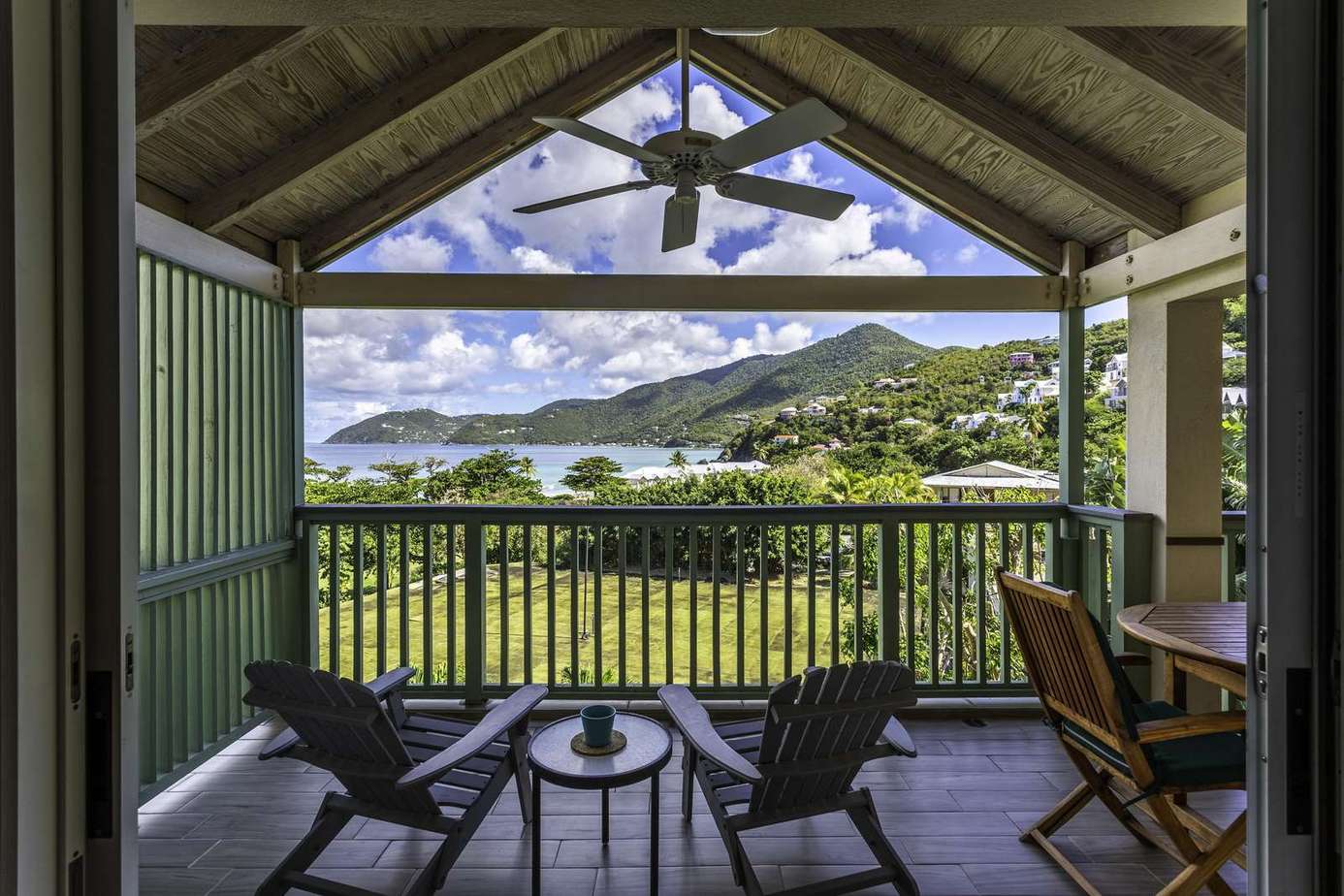 Relax on the covered balcony with stunning mountain views